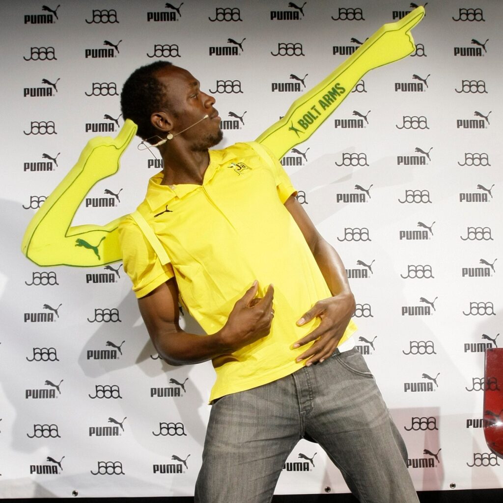 Usain Bolt posing with his "Bolt Arms"